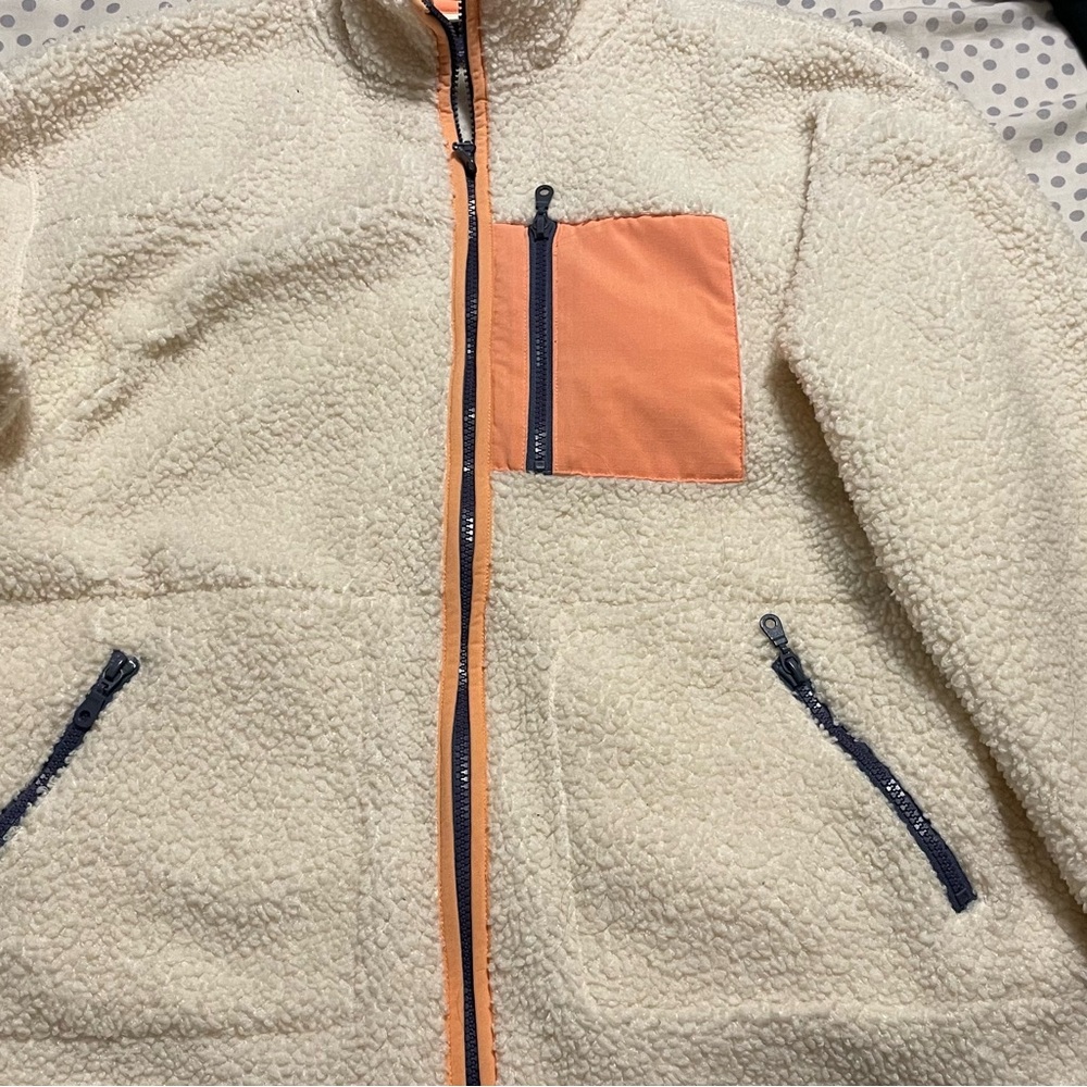 Universal Thread Cream Sherpa Jacket with peach accents.